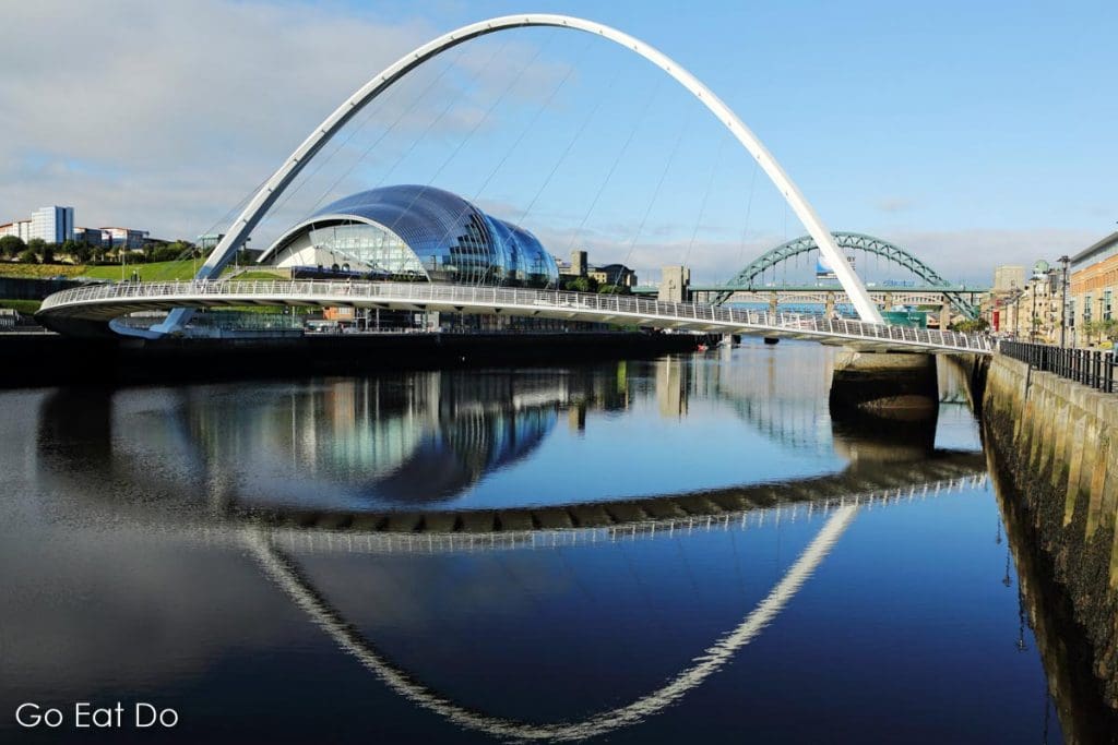 Gateshead Millennium Bridge and the Tyne Bridge spanning the River Tyne between Gateshead and Newcastle in north-east England