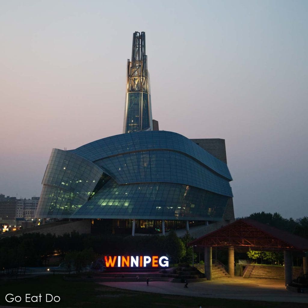 Illuminated Winnipeg sign outside of the Canadian Museum for Human Rights as dusk falls on Manitoba, Canada