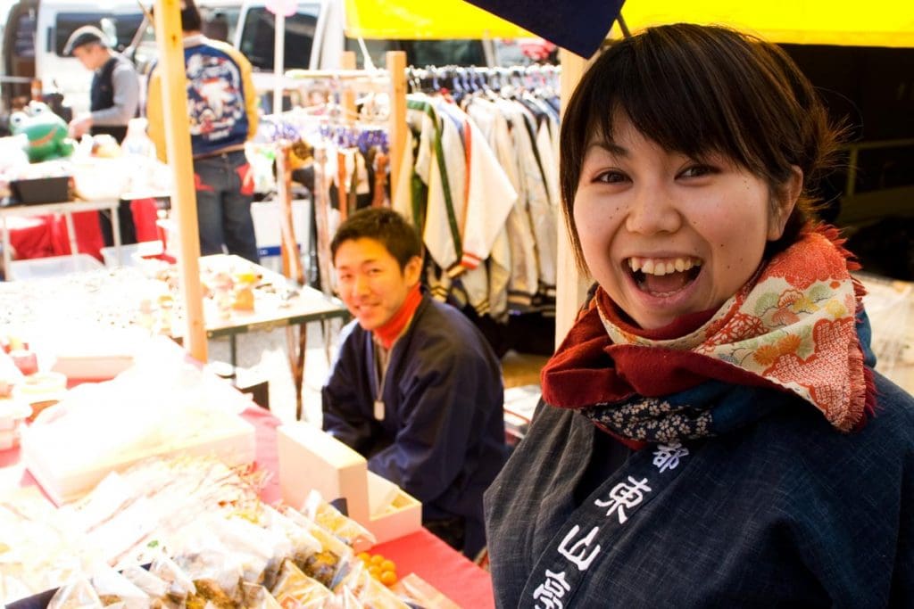 A welcoming stall holder at the Kobosan market in Kyoto, Japan