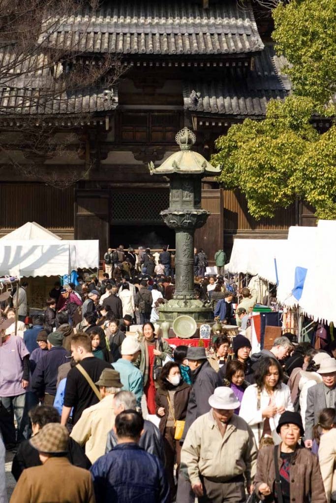 Visitors to the Kobo-san market in the precincts of the Toji Temple in Kyoto, Japan