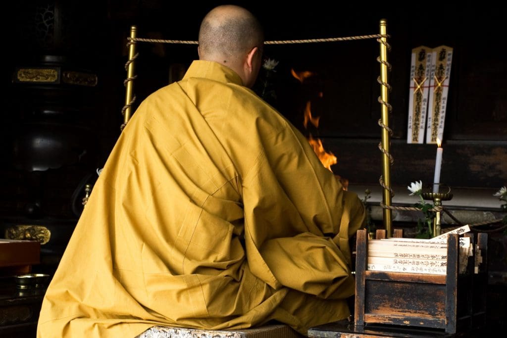 A Buddhist priest performs a ceremony at a shrine at the Toji Temple in Kyoto, Japan