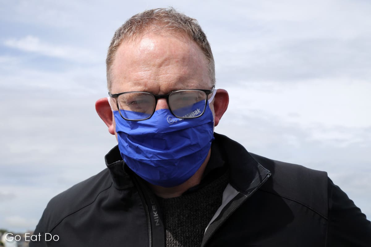 Travel blogger Stuart Forster with fogged glasses while wearing a face covering