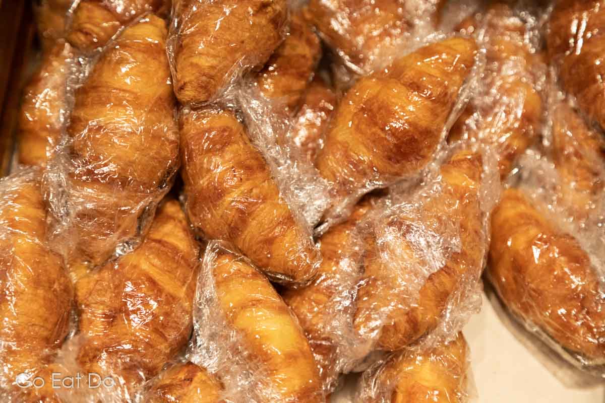 Croissants wrapped in cling film on a hotel breakfast buffet as a measure to limit travellers' exposure to the coronavirus