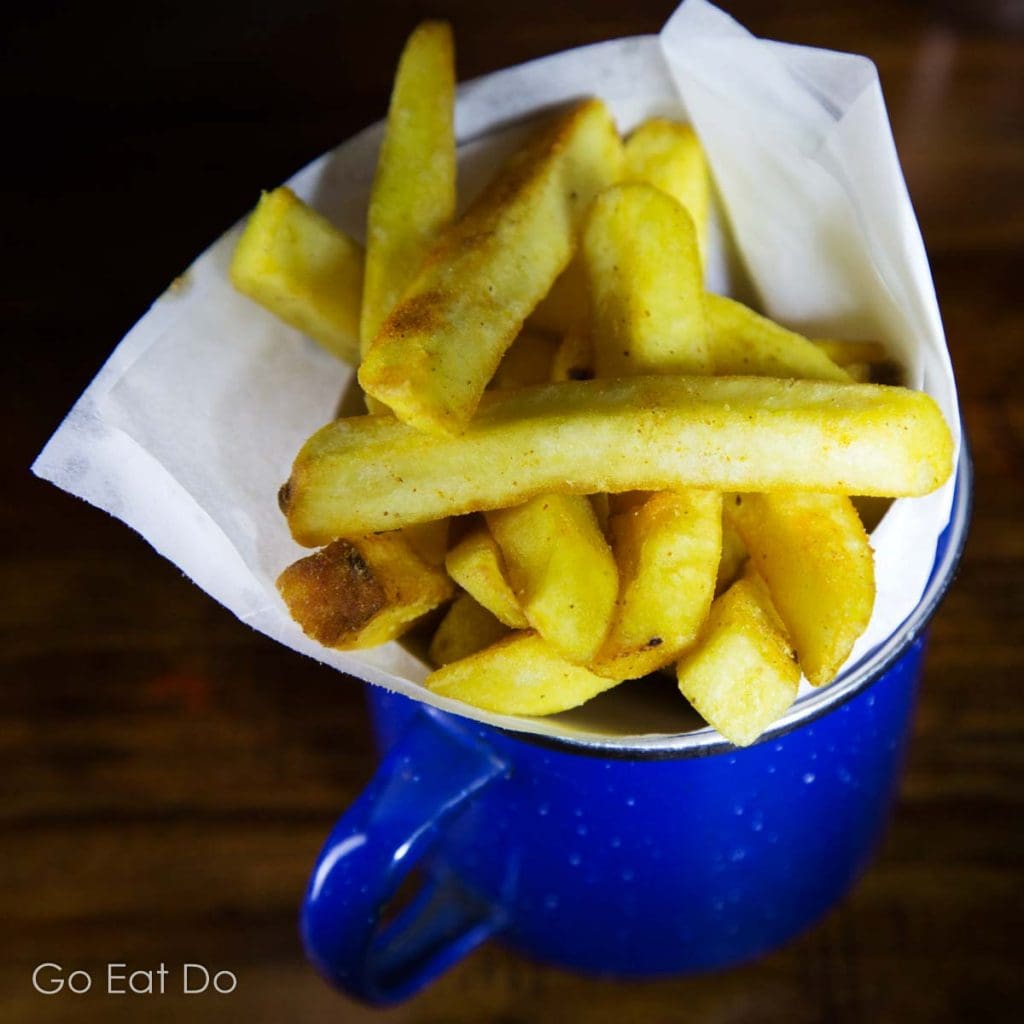 Chips served in a mug at a restaurant in North East England.
