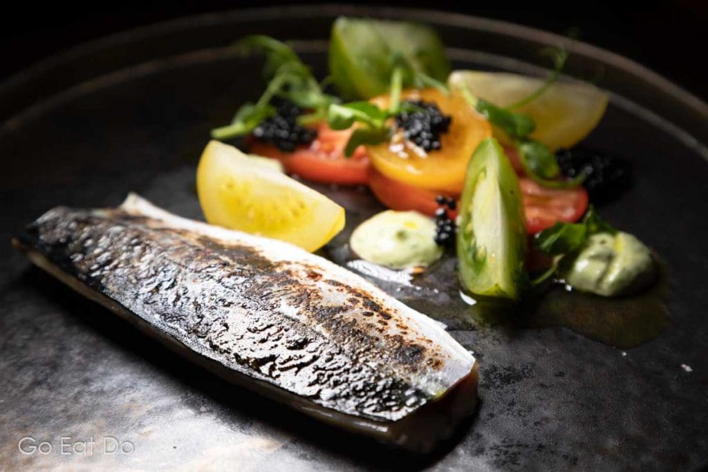 Cured and torched mackerel with caviar served with a salad featuring tomato and basil at the Knights Restaurant