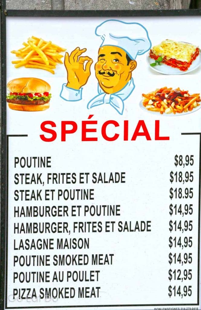 Menu, written in French, listing specials including poutine outside of a Montreal restaurant.