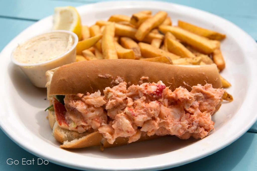 A driving holiday in Nova Scotia means opportunities to taste traditional cuisine such as this lobster roll with fries and lemon tartare sauce