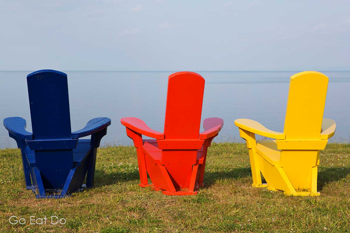 Colourful wooden seats overlooking the Atlantic on Nova Scotia's Northumberland Shore, a region of the province that can be explored while following the Sunrise Trail scenic driving route