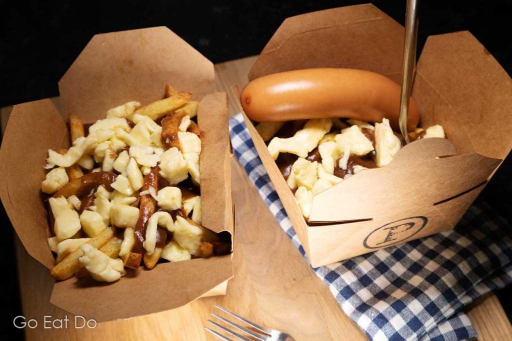 What is the perfect poutine topping? Here homemade poutine is served with a Frankfurter.