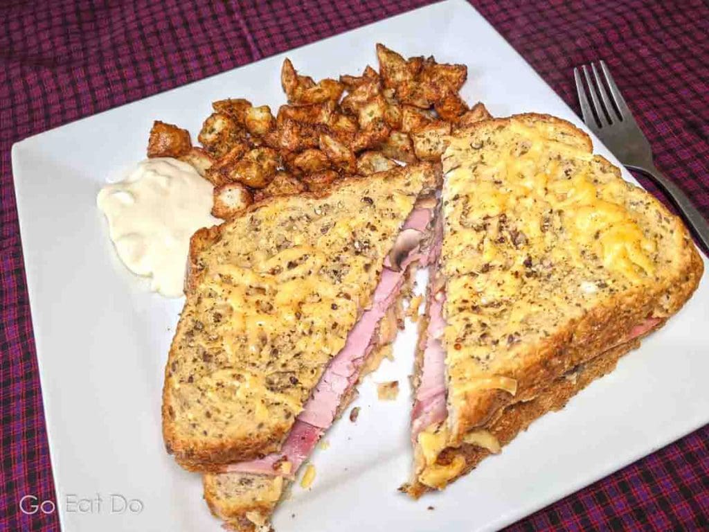 Oven-baked ham, egg and cheese sandwich with herby tater tots made using the Ninja Foodi's air fryer function
