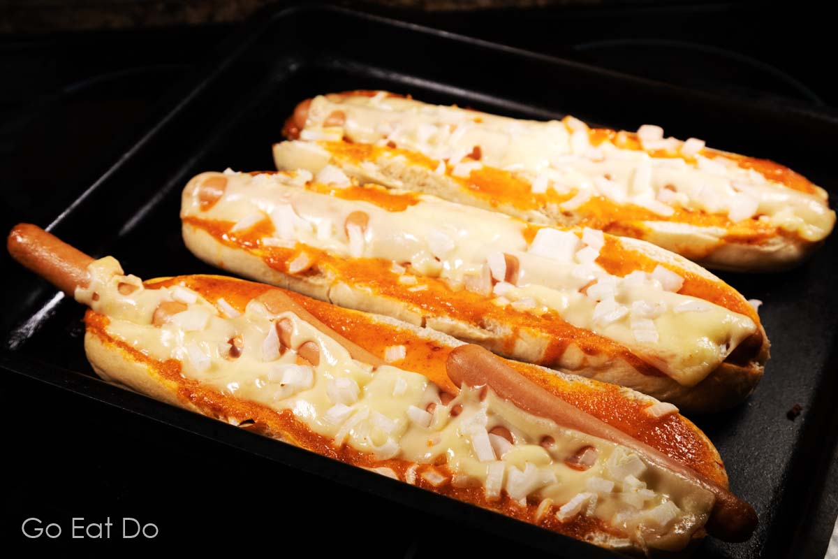 This Spanish hot dog recipe requires an oven to bake hot dogs and other ingredients in a baguette.