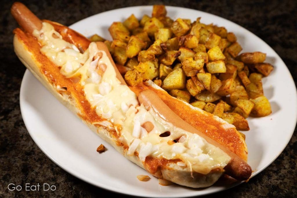 The product of this Spanish hot dog recipe served with tater tots prepared in an air fryer.