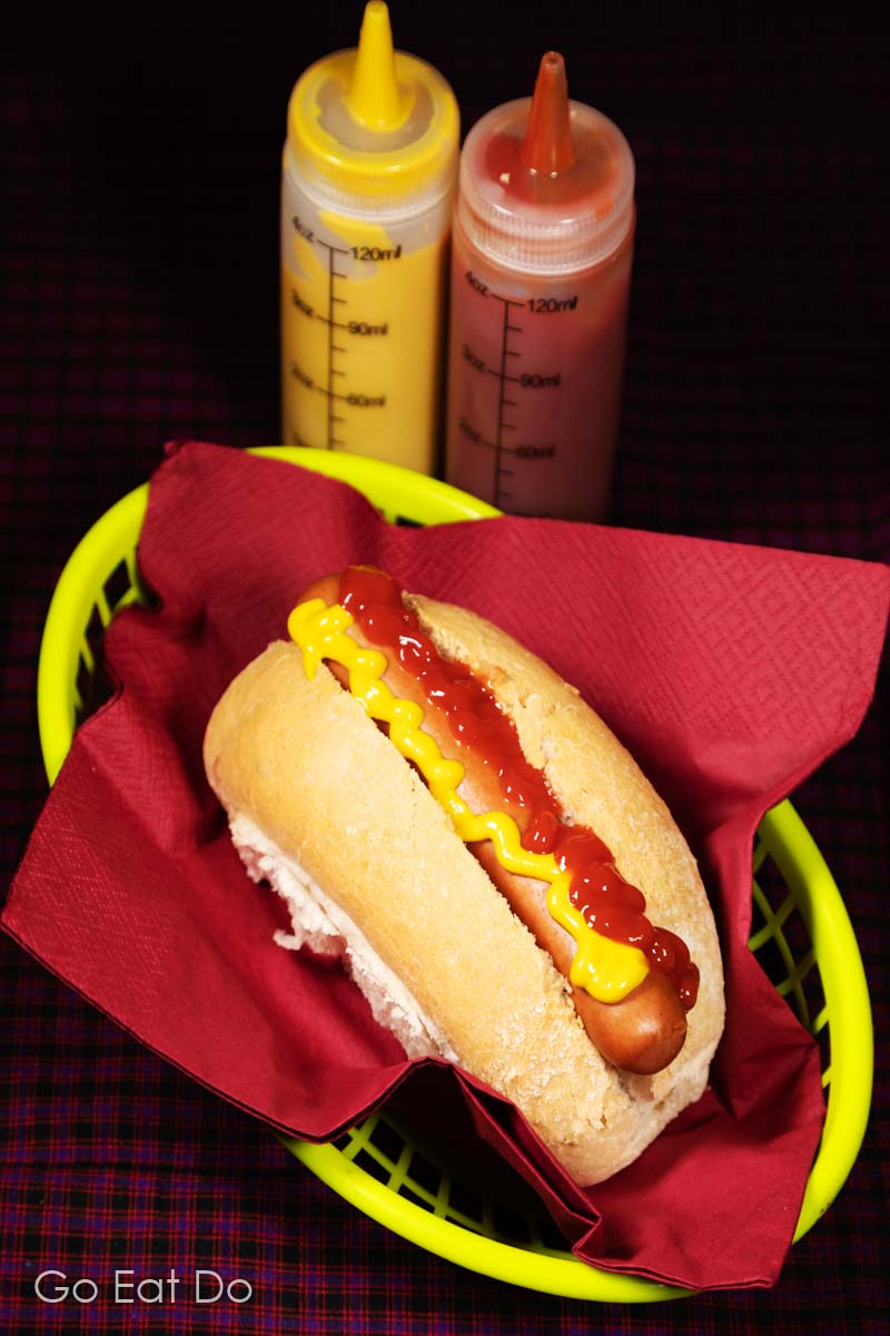 Hot dogs served in a finger bun with mustard and ketchup.