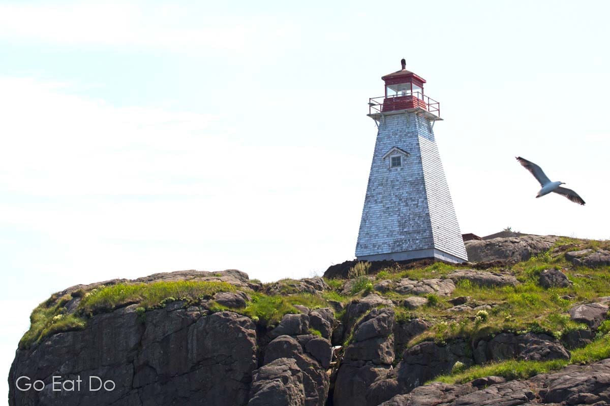 Boar's Head Lighthouse at Digby Neck, seen during a whale-watching tour in the Bay of Fundy.