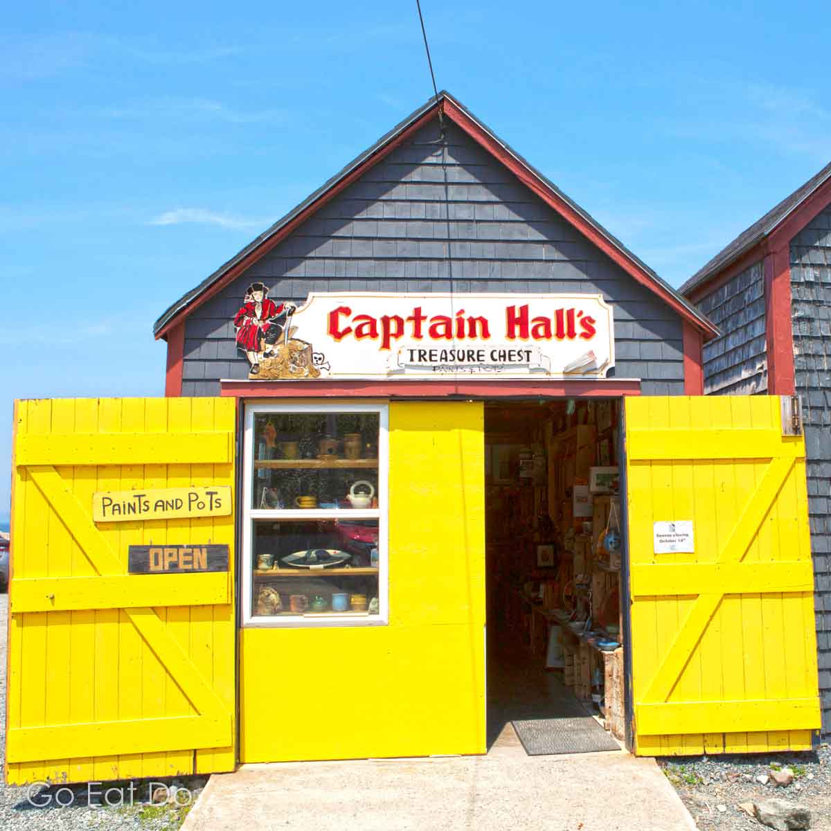 Bright colours contrasting with the blue of Nova Scotia's summer sky can help make strong images. This is Captain Hall's Treasure Chest at Halls Harbour Lobster Pound.