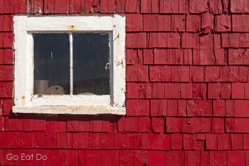 Red shingles on a house in a fishing village. Details and textures can provide subjects for photographers in Nova Scotia.