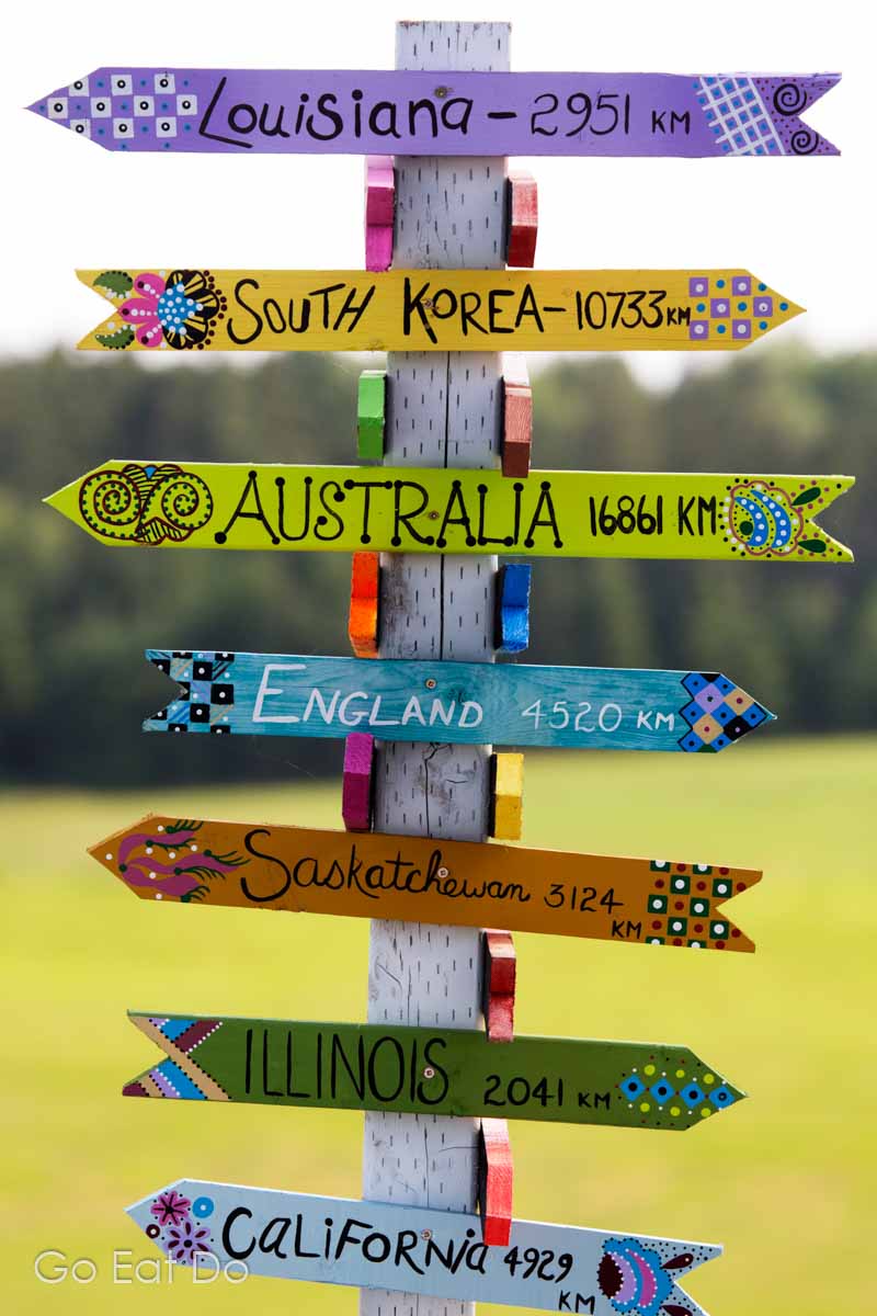 A colourful sign point to Louisiana, South Korea, Australia, England, Saskatchewan, Illinois and California in Nova Scotia, Canada.