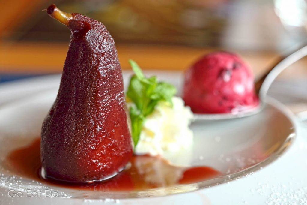 Ideal for boosting energy after winter sports in Switzerland. Drunken pear served with cream and ice cream.