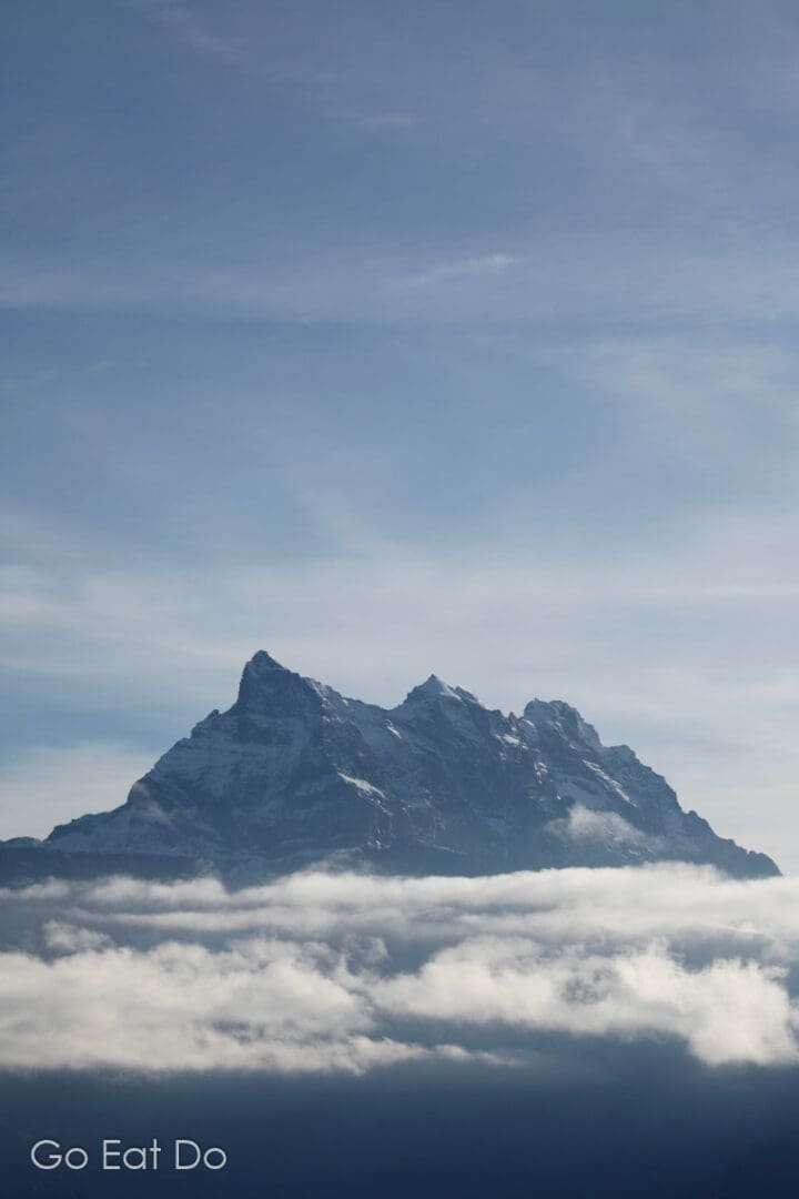 Wisps of cloud under the summit of the mountain known as Dents du Midi (Teeth of the South) in Switzerland.