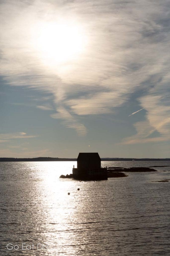 Silhouetted fishing shack on a sunny afternoon at Blue Rocks.