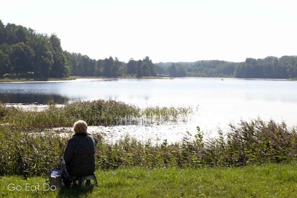 A woman enjoys a moment of reflection and tranquillity in Latgale, the Land of Blue Lakes. Eco-tourism counts among the reasons to visit eastern Latvia.