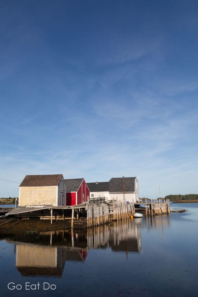 Rustic fishing shacks reflecting in the water at Blue Rocks, a Nova Scotian fishing village near Lunenburg.
