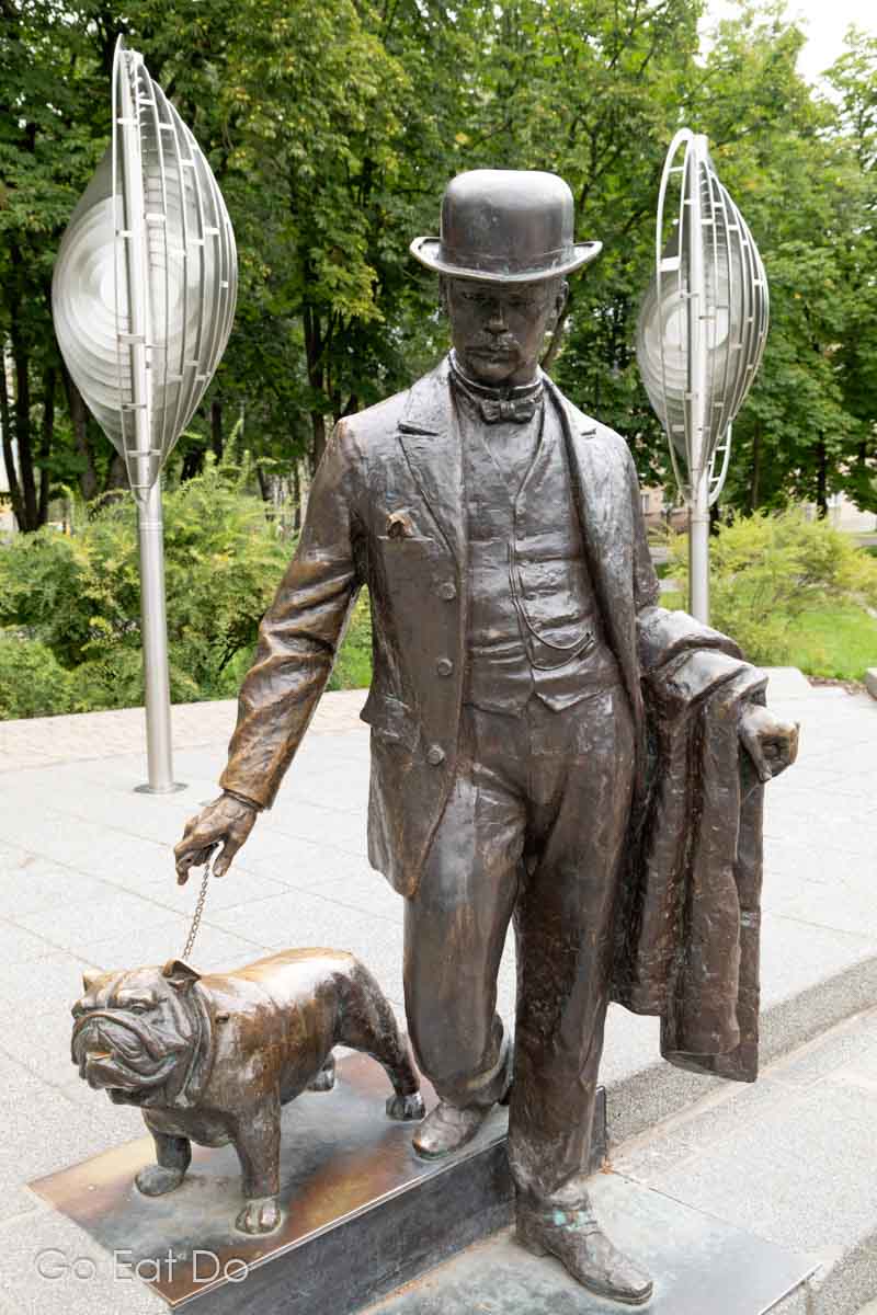 Bronze statue of Pavel Dubrovin, a former mayor of Daugavpils, walking a bulldog while wearing a bowler hat in Dubrovin Park in the heart of Latgale's biggest city.
