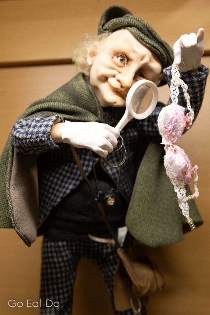 Doll inspecting a bra with a magnifying glass, one of the works of Jeļena Mihailova at the Museum of Dolls in Preili in Latgale, Latvia.