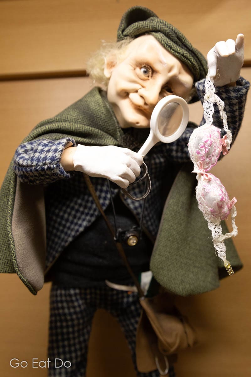 Doll inspecting a bra with a magnifying glass, one of the works of Jeļena Mihailova at the Museum of Dolls in Preili, one of the top tourist attractions in Latgale, Latvia.