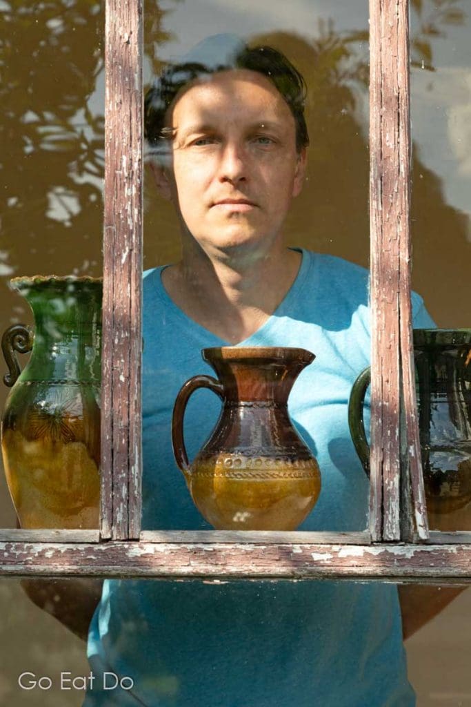 A potter by examples of Latgalian pottery at the House - Museum of Polikarps Čerņavskis near Preili, Latvia.