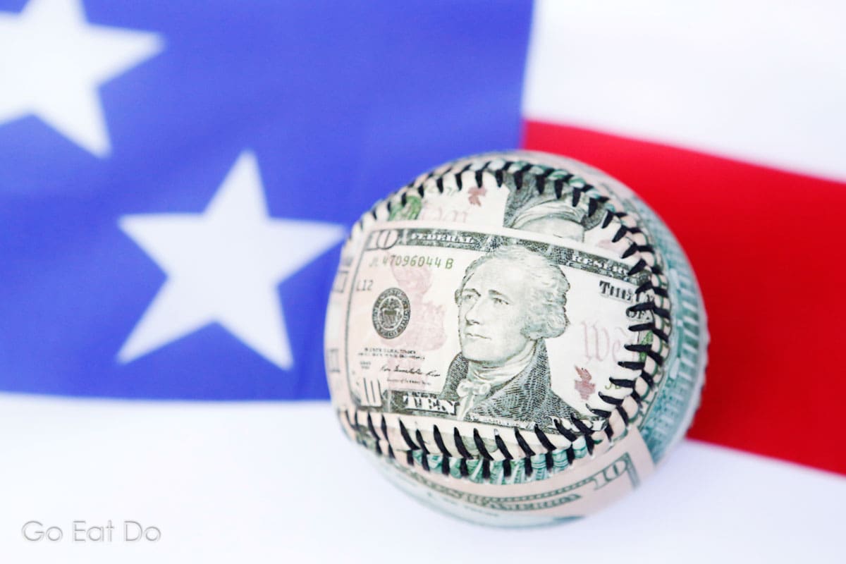 Money ball - the face of Alexander Hamilton on a $10 bill on a baseball. The big advertising money is spent on Super Bowl Sunday. 