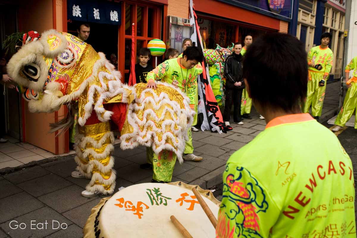 It's common for dragons and lions to move between restaurants and other business premises seeking offerings during Chinese New Year celebrations. The tradition that can be traced back to the mythological foundations of the Chinese Spring Festival.