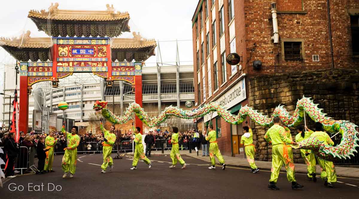 Dragon dance performed by members of Edmund Ng's Choi Lee Fut Kung Fu Club during Chinese New Year festivities on the streets of Chinatown in Newcastle, England.