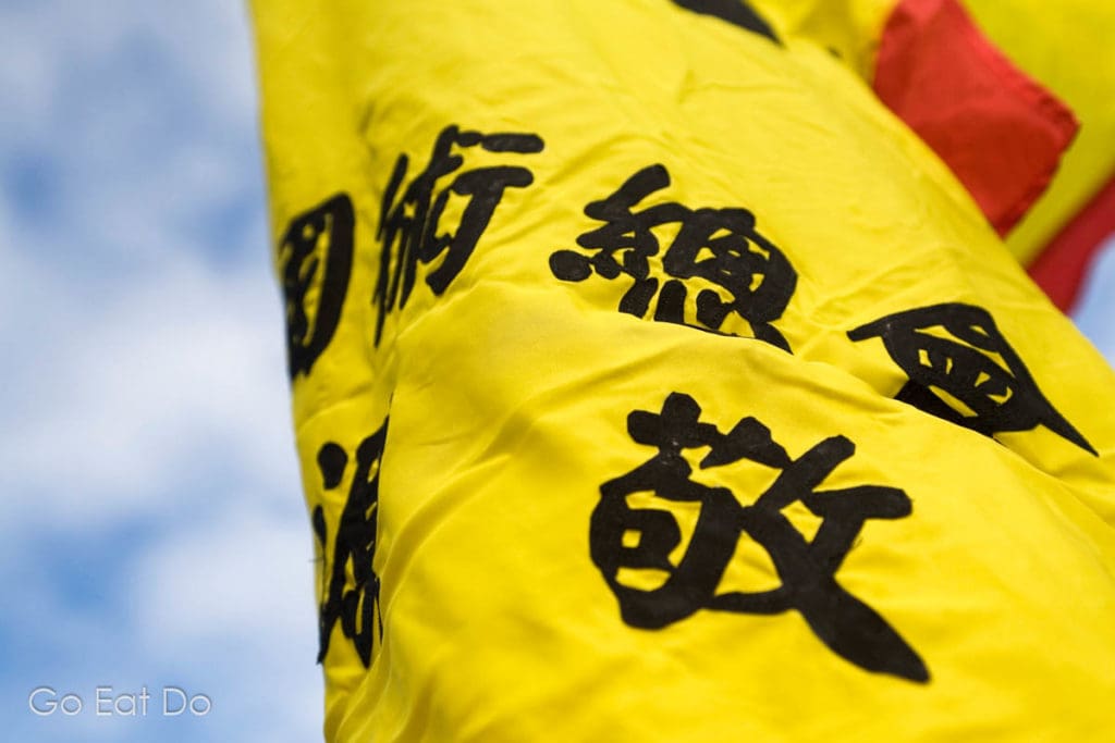 A yellow banner bearing Chinese characters blows in the wind during Chinese New Year celebrations in Newcastle's Chinatown in North East England.