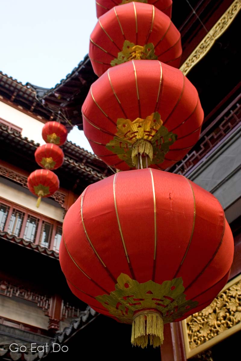 Red lanterns hanging from buildings in Shanghai, China.
