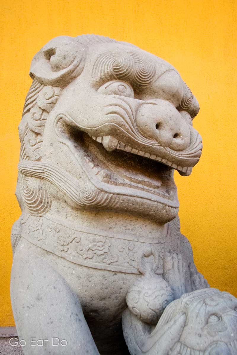 A stylised statue of a lion guarding the Jade Buddha Temple in Shanghai.