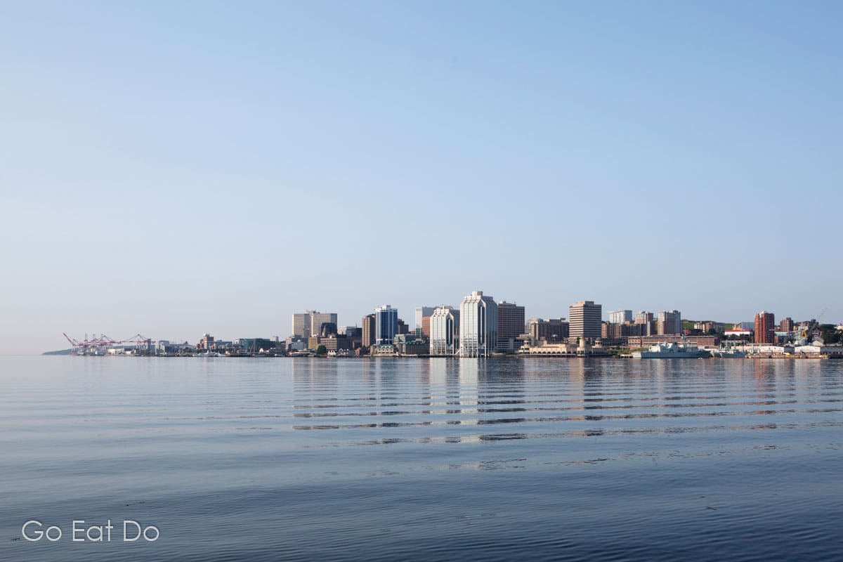 Looking across the calm water of Halifax Harbour towards Halifax on a sunny day in Nova Scotia.