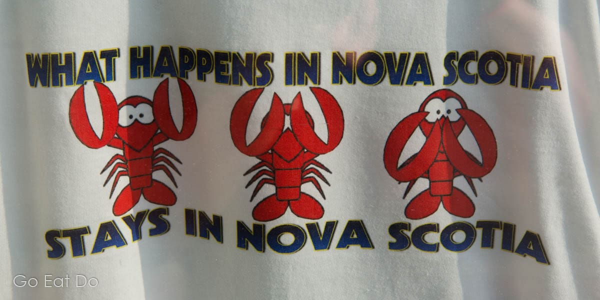"What happens in Nova Scotia stays in Nova Scotia," featuring cartoon lobsters on a T-shirt.