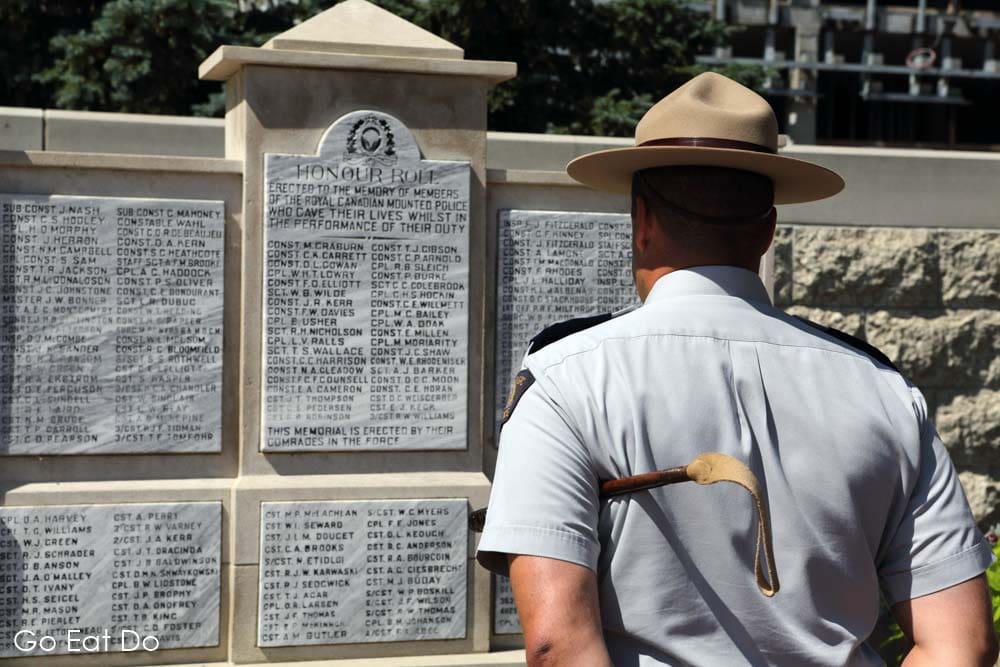 An officer looks at the Royal Canadian Mounted Police Honour Roll in Regina, Saskatchewan. The memorial records the name of all members of the RCMP who gave their lives during the performance of their duty.