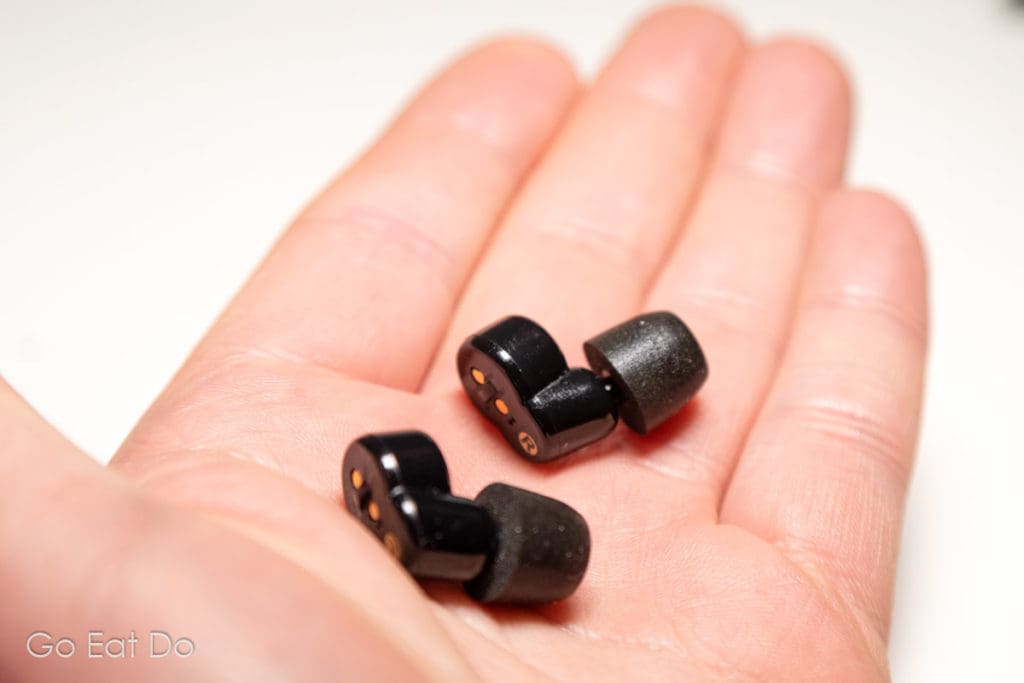 QuietOn Sleep Earbuds in the palm of travel blogger Stuart Forster's hand.