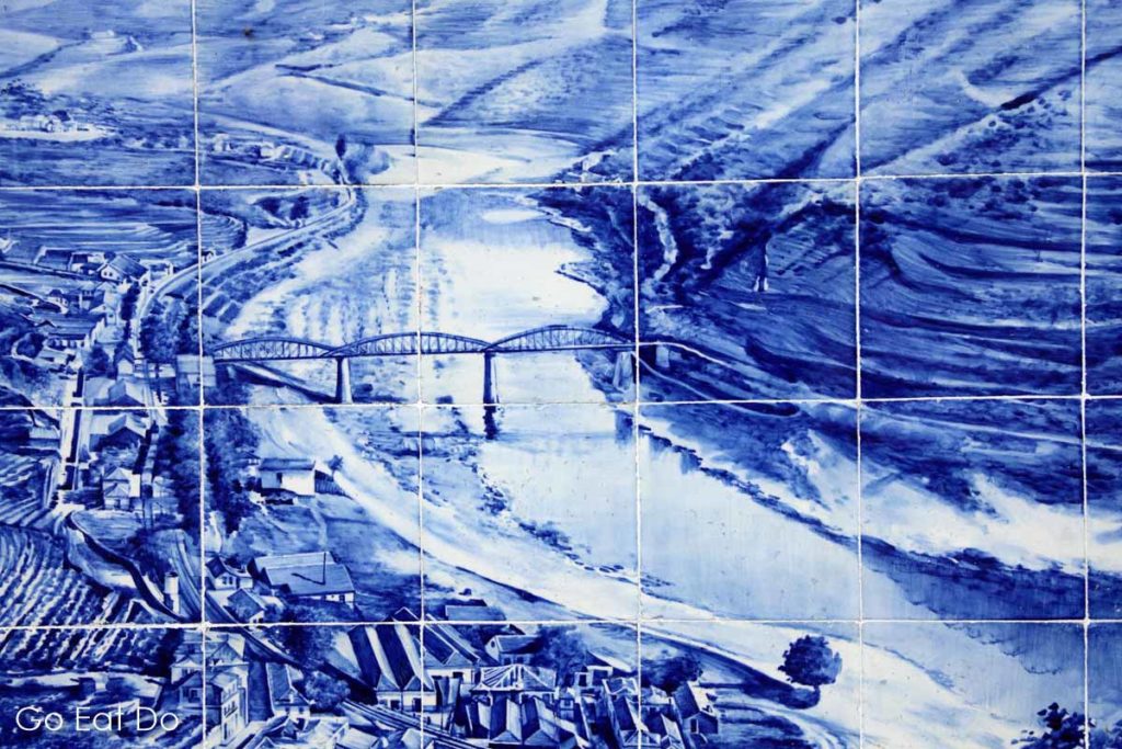 The Douro Valley depicted in blue and white on traditional Portuguese azulejo tiles at the railway station in Pinhao.