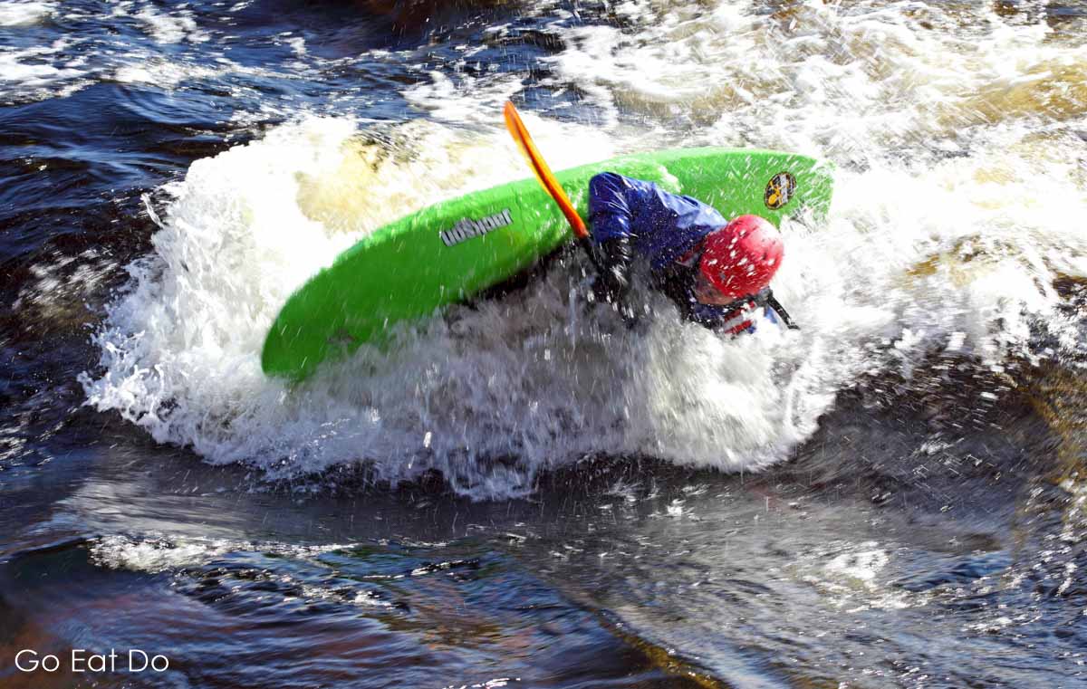 A kayaker practises kayaking skills in the white water rapids of the River Tammerkoski in central Tampere.