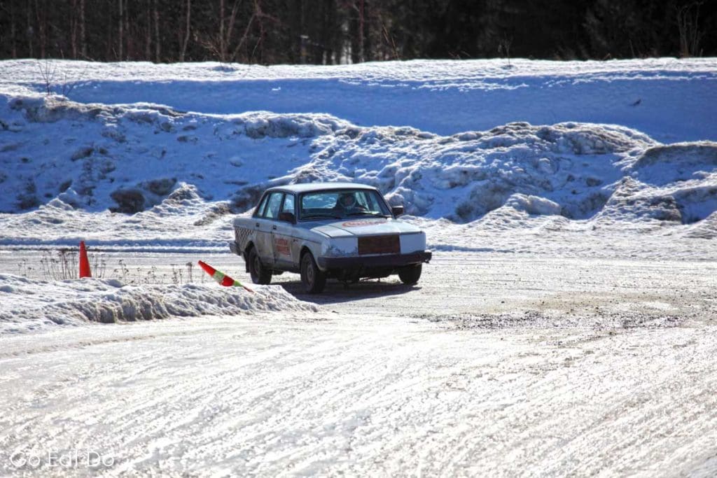 A Volvo 2400 car races around a corner of the Motor Space racing circuit on the edge of Tampere, Finland.