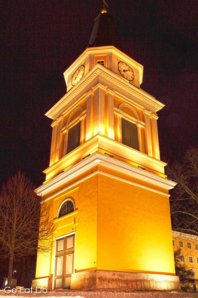 The illuminated clock tower of Old Church, designed by Carl Engel and built in 1828-29 while Tampere was an expanding industrial hub.