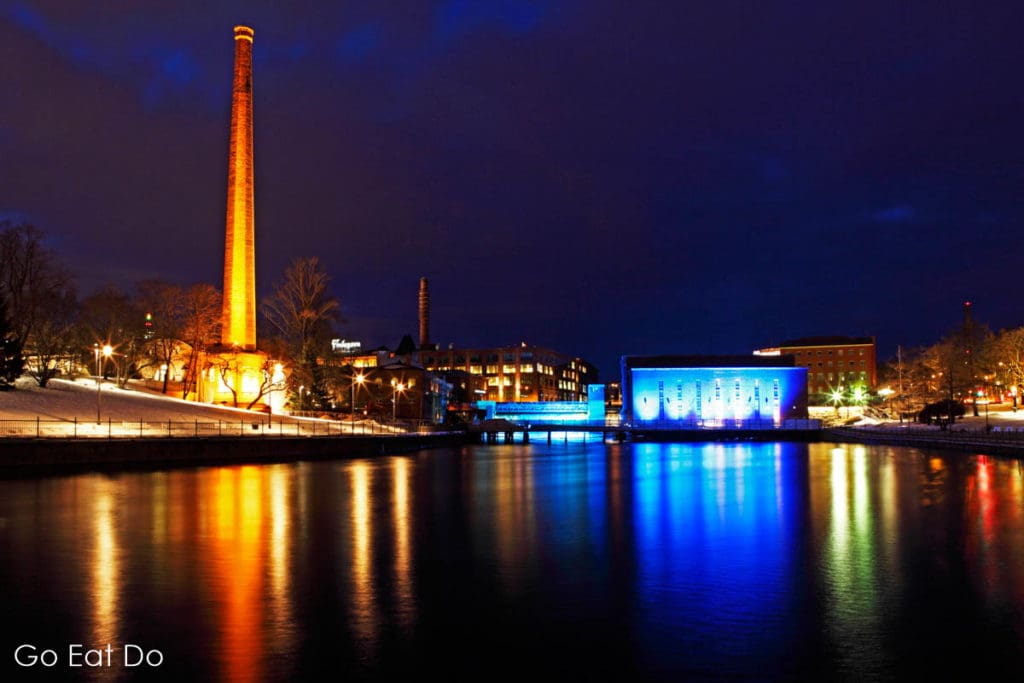 Coloured illuminations at the Finlayson Complex reflect in the water of the River Tammerkoski in Tampere, Finland.