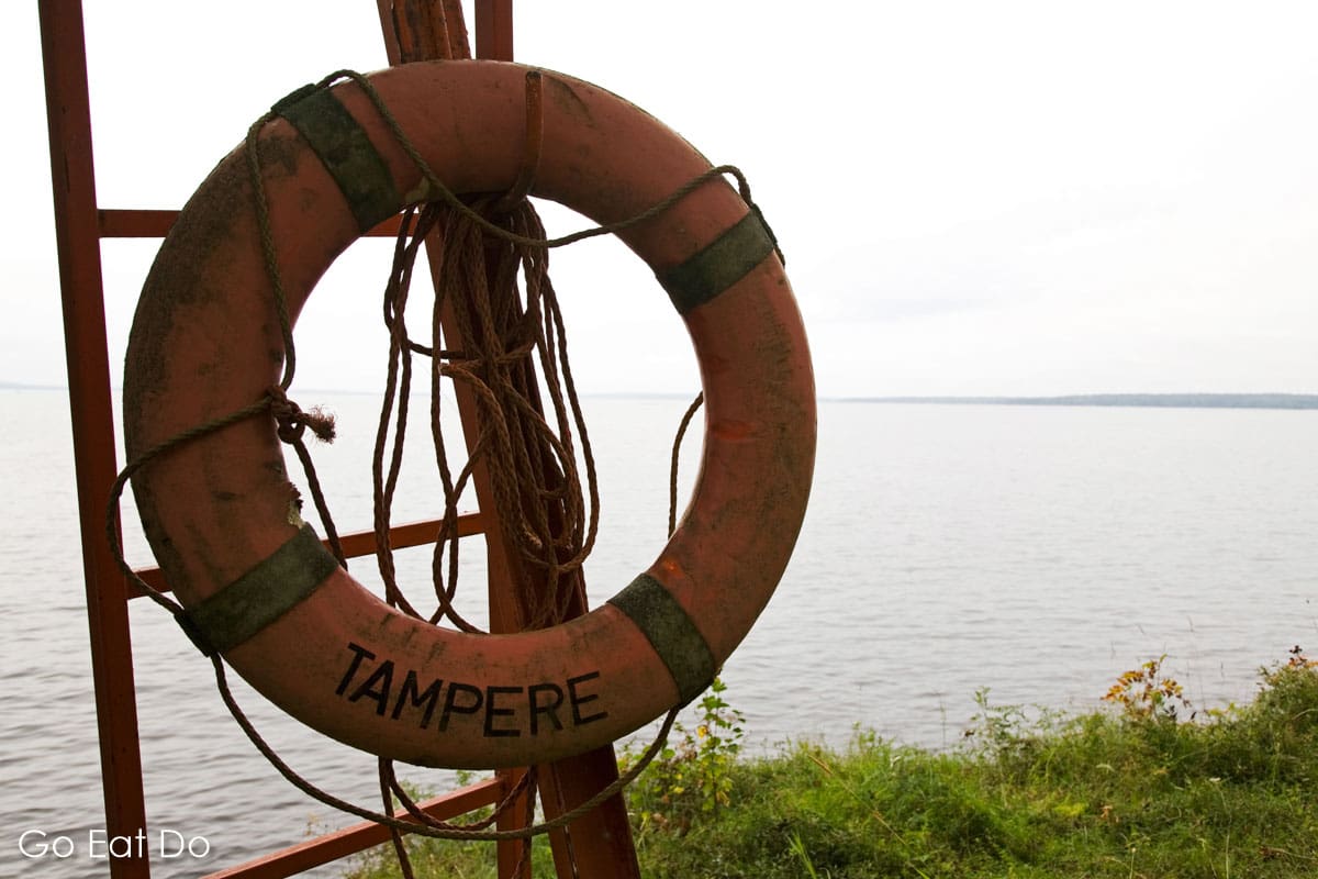 Lifebuoy by the shore of Nasijarvi Lake, a popular destination for anglers in summer and autumn.