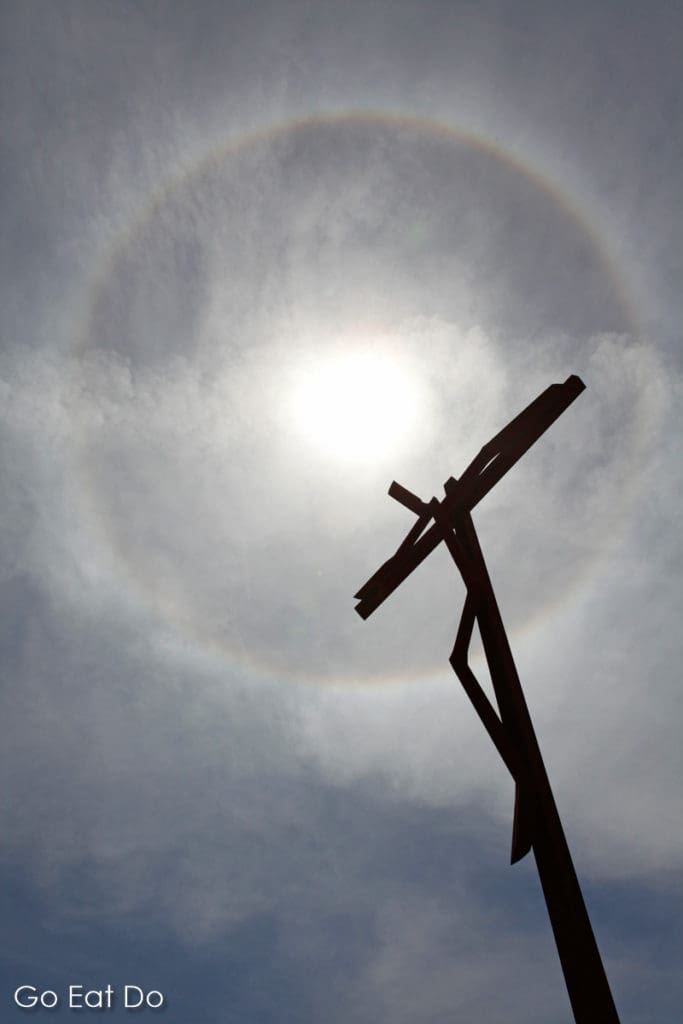 Solar halo above Fatima, Portugal, on 13 May 2011. It is seen behind Robert Schad's High Cross (Cruz Alta) sculpture.