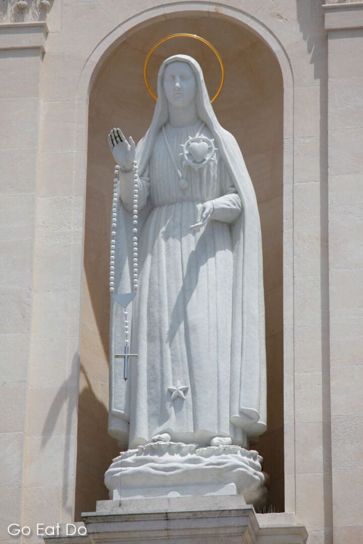 Statue of the Virgin Mary on the Basilica of Our Lady of the Rosary in Fatima, Portugal.