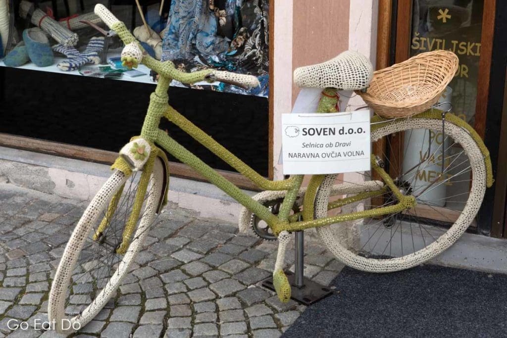Bicycle with a knitted cover outside of a shop in Maribor...ideal for keeping a bike warm on winter days?