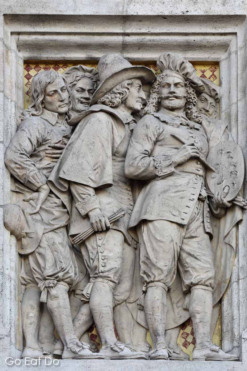 Bas relief depiction of Dutch Golden Age artists on the facade of Amsterdam's Rijksmuseum, one of the best museums in the Netherlands.